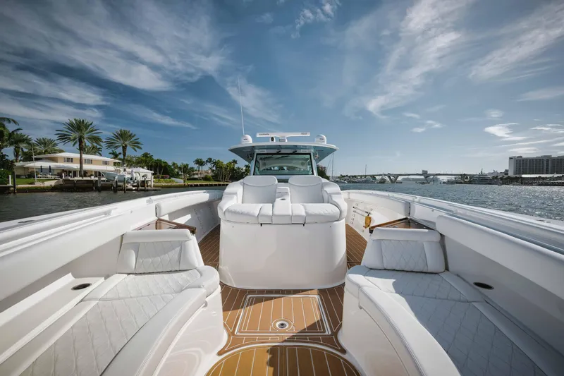 Slide: The Image of 2022 HCB 65 Estrella luxury yacht with white seating and wooden deck. - 45