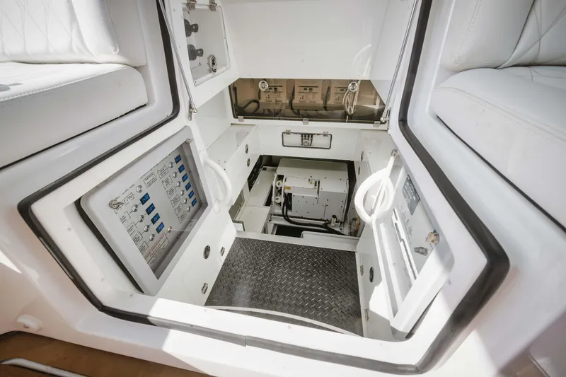 Slide: The Image of Control panel and engine room of 2022 HCB 65 Estrella boat with white interior. - 49