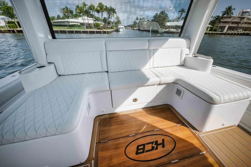 Slide: The Image of Luxurious seating area on the 2022 HCB 65 Estrella yacht with waterfront view. - 7