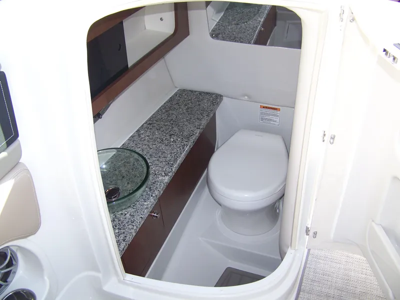 Slide: The Image of 2024 Crownline 280 boat bathroom with granite countertop and modern fixtures. - 11