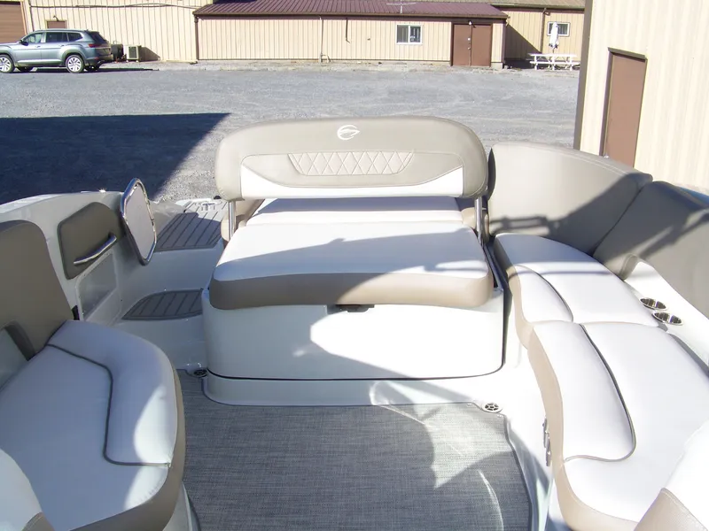 Slide: The Image of 2024 Crownline 280 boat interior with beige and white seating. - 12