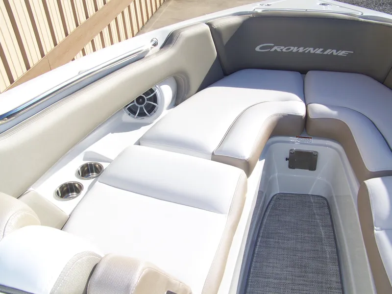 Slide: The Image of 2024 Crownline 280 boat interior with cushioned seating and cup holders. - 5