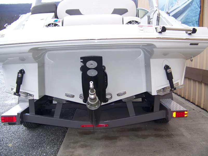 Slide: The Image of 2024 Crownline 260 boat rear view on trailer. - 13