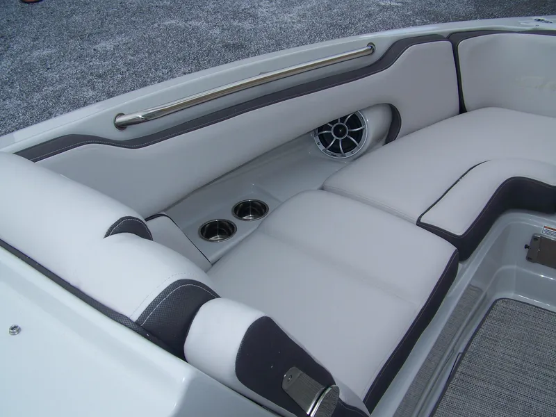 Slide: The Image of 2024 Crownline 260 boat interior with cushioned seating and cup holders. - 6