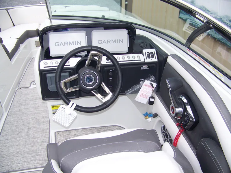 Slide: The Image of 2024 Crownline 260 boat cockpit with Garmin navigation system and modern steering wheel. - 7