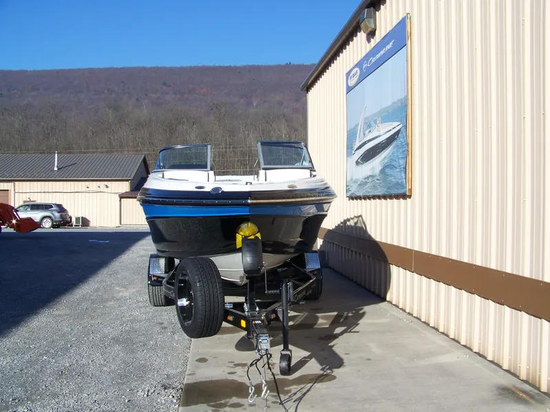 Slide: The Image of 2024 Crownline 240 boat on trailer outside dealership. - 3