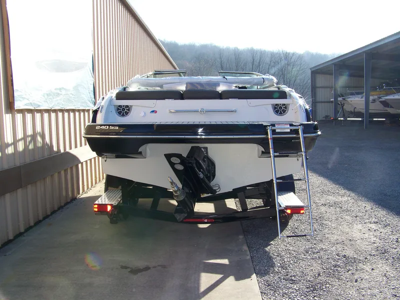Slide: The Image of 2024 Crownline 240 boat rear view with ladder and trailer. - 4