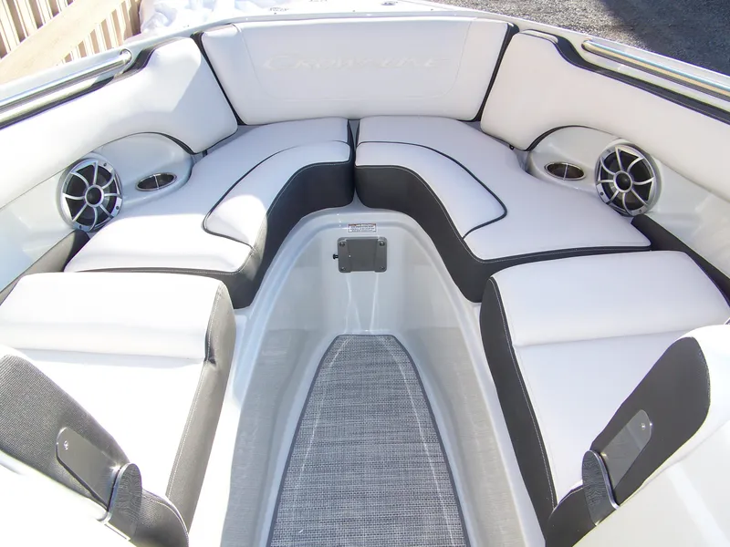 Slide: The Image of 2024 Crownline 240 boat interior with white and black cushioned seating. - 7