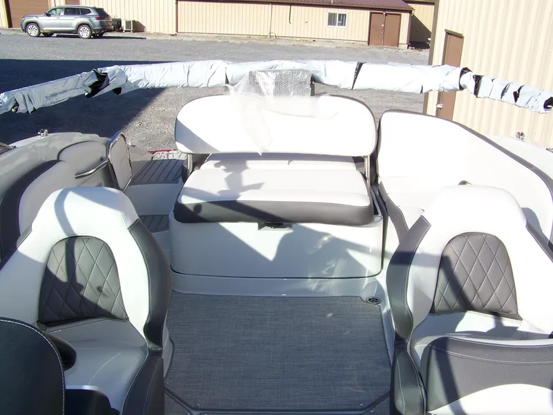 Slide: The Image of 2024 Crownline E235 boat interior with seating and covered canopy. - 7