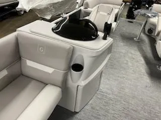 Slide: The Image of 2023 Sweetwater 2286SBX boat interior with beige seating and control console. - 13
