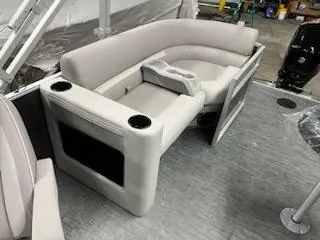 Slide: The Image of 2023 Sweetwater 2286SBX boat interior with plush seating and cup holders. - 2