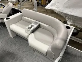 Slide: The Image of 2023 Sweetwater 2286SBX boat interior with gray cushioned seating and cup holders. - 6