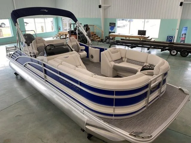 Slide: The Image of 2024 Bennington 23 RSB pontoon boat with blue and white exterior in showroom. - 4