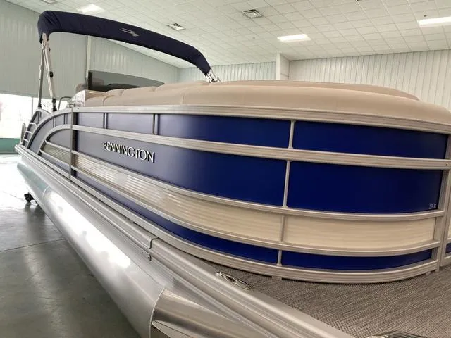 Slide: The Image of 2024 Bennington 23 RSB pontoon boat with blue and white exterior in showroom. - 6