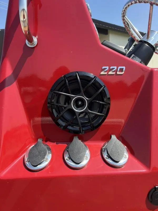 Slide: The Image of Red 2023 Excel Boats 220 Bay Pro dashboard with speaker and controls. - 10