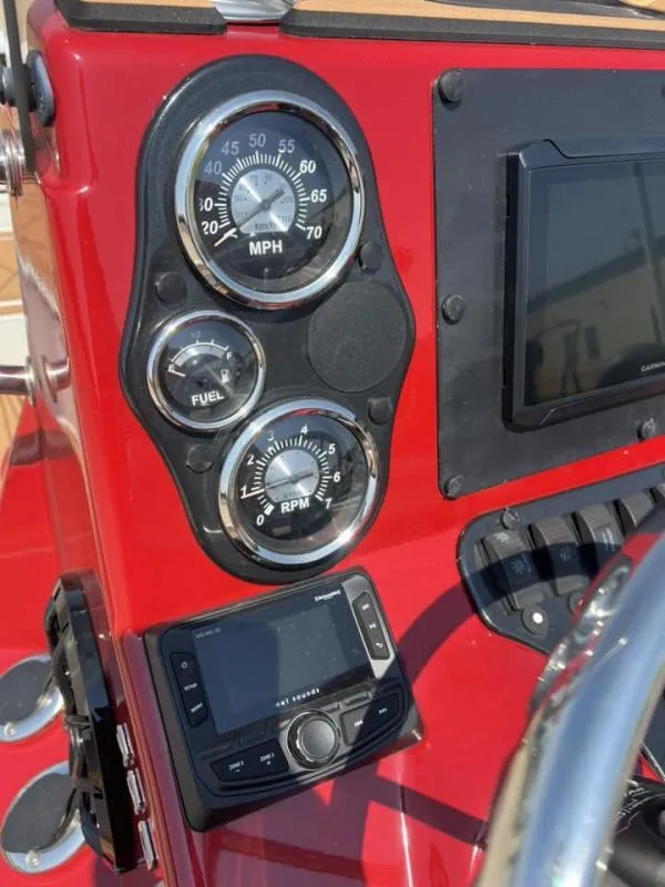 Slide: The Image of Dashboard of 2023 Excel Boats 220 Bay Pro with gauges and controls. - 12