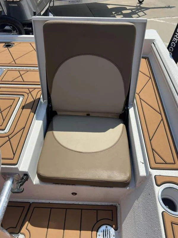 Slide: The Image of 2023 Excel Boats 220 Bay Pro seat with tan upholstery and deck detail. - 14
