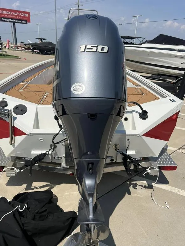 Slide: The Image of 2023 Excel Boats 220 Bay Pro with Yamaha 150 outboard motor, parked at dealership. - 17