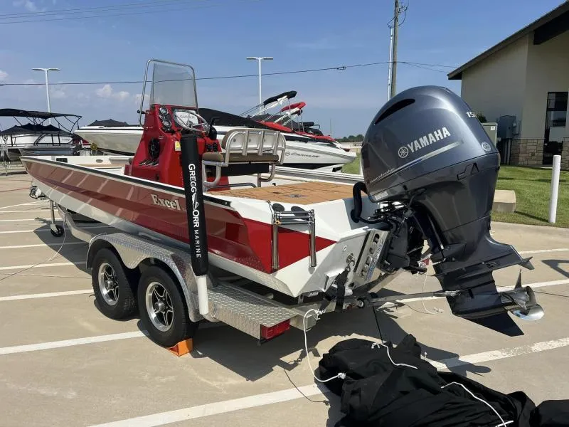 Slide: The Image of 2023 Excel Boats 220 Bay Pro with Yamaha engine on trailer in parking lot. - 4