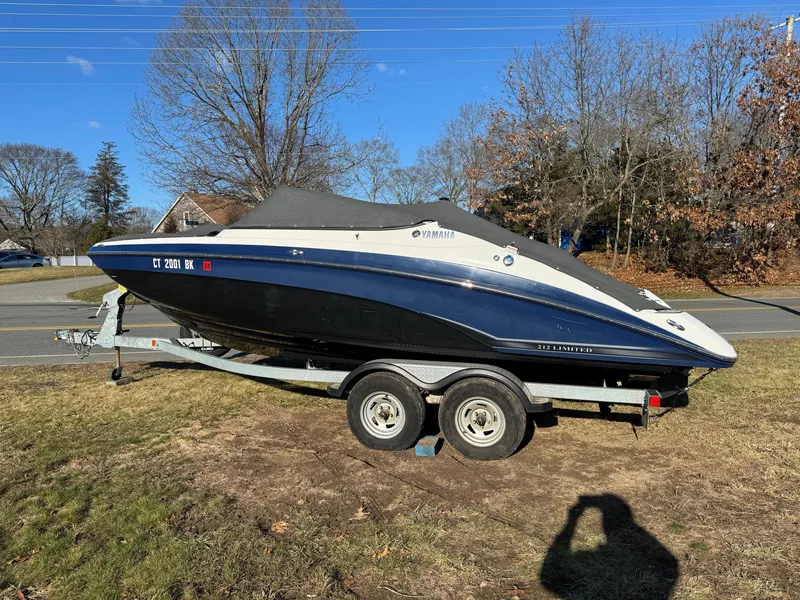 The Image of 2017 Yamaha Boats 212 Limited on a trailer in a grassy area. - 1