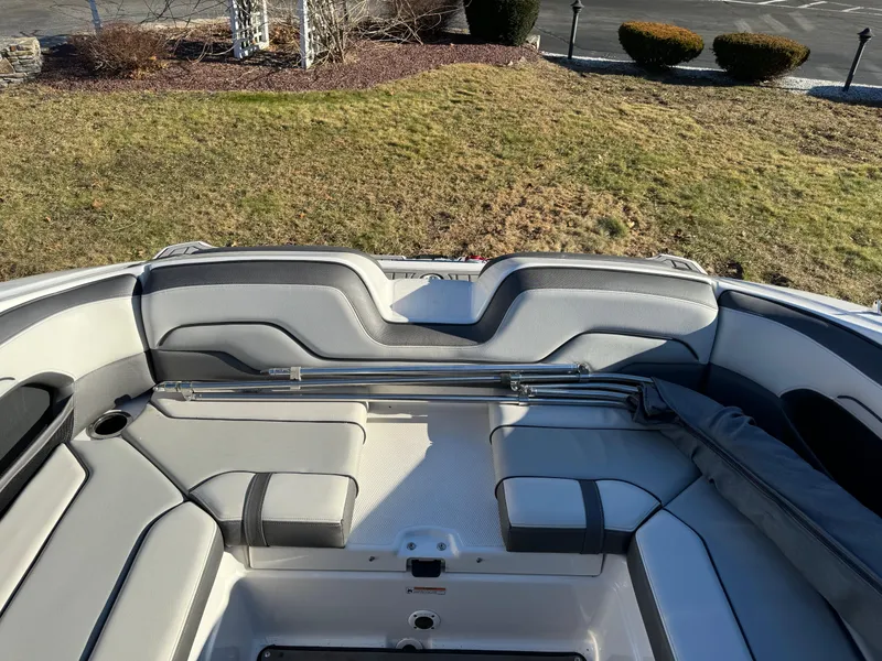Slide: The Image of 2017 Yamaha Boats 212 Limited interior seating area with gray upholstery. - 10