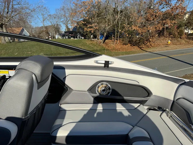 Slide: The Image of Interior of a 2017 Yamaha Boats 212 Limited, featuring gray seating and a speaker. - 11