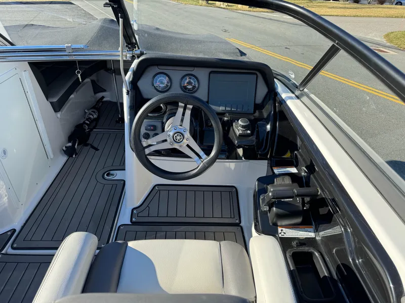 Slide: The Image of 2017 Yamaha Boats 212 Limited cockpit with steering wheel and dashboard controls. - 14