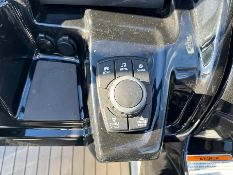 Slide: The Image of Control panel of a 2017 Yamaha Boats 212 Limited, featuring media and cruise control buttons. - 16
