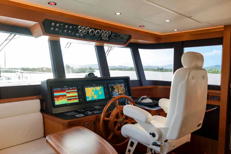 Slide: The Image of Helm of 2026 Selene 60 Ocean Explorer yacht with navigation screens and captain's chair. - 13