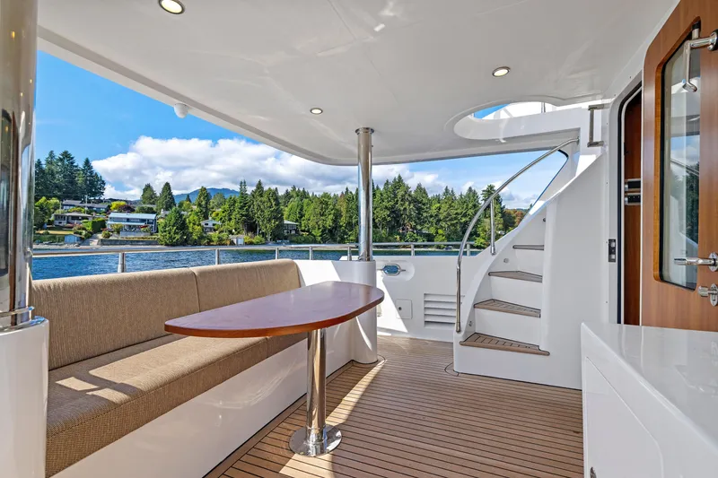 Slide: The Image of Luxurious Selene 60 Ocean Explorer yacht deck with seating, table, and spiral staircase, 2026 model. - 21