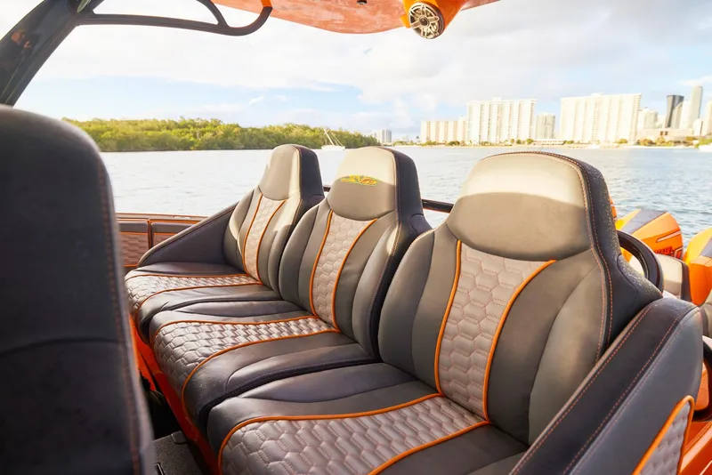 Slide: The Image of Luxurious seating on 2023 Midnight Express 43' Solstice boat, with waterfront cityscape in background. - 14