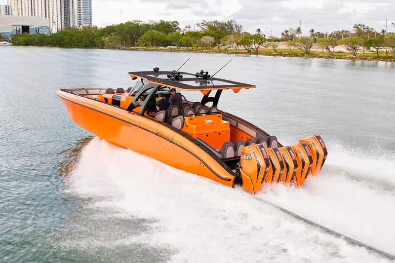 Slide: The Image of 2023 Midnight Express 43' Solstice boat cruising on water, vibrant orange design. - 2