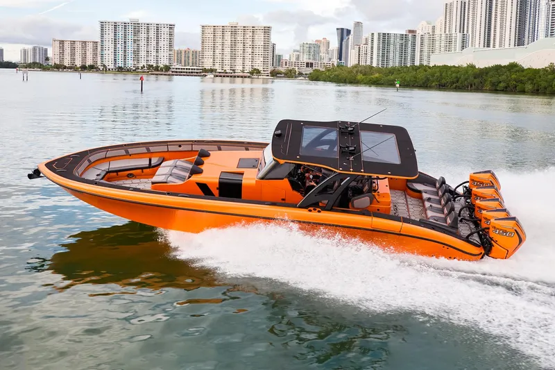 Slide: The Image of 2023 Midnight Express 43' Solstice boat cruising on a calm urban waterway. - 3