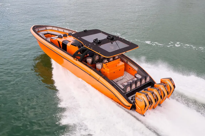 Slide: The Image of 2023 Midnight Express 43' Solstice boat speeding on water, vibrant orange design. - 5