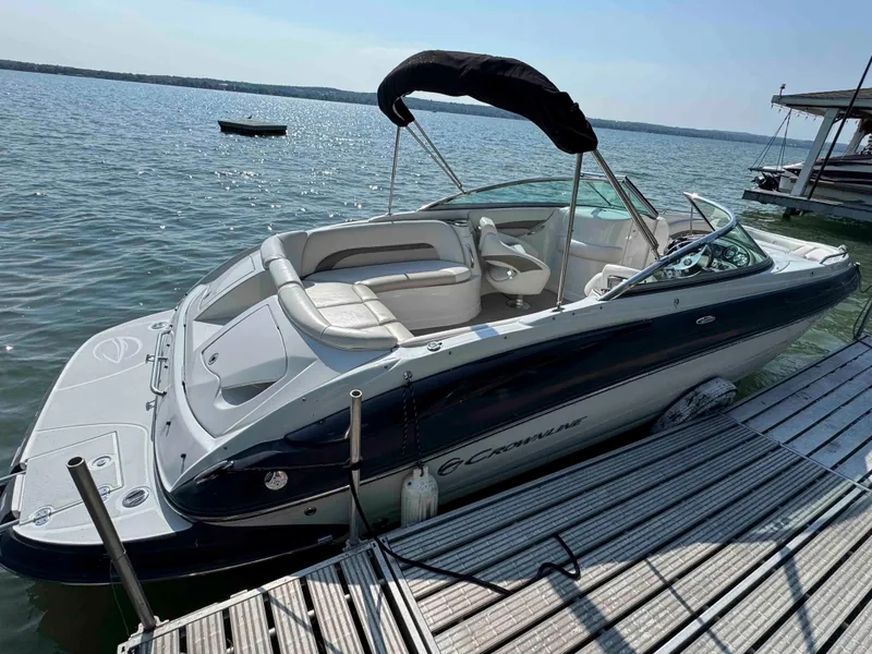 The Image of 2010 Crownline 240 LS boat docked on a sunny lake. - 0