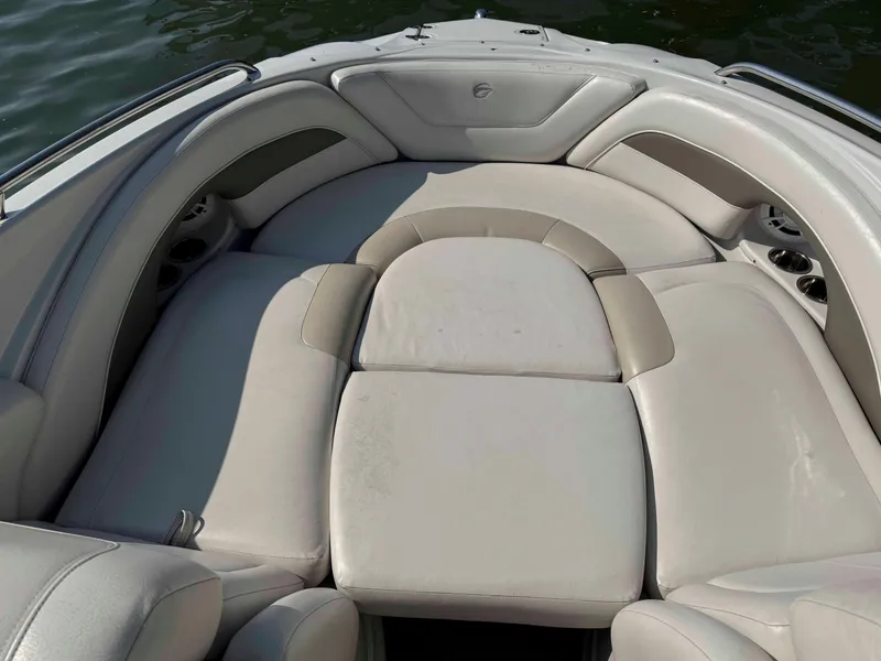 Slide: The Image of 2010 Crownline 240 LS boat interior with cushioned seating and cup holders. - 10
