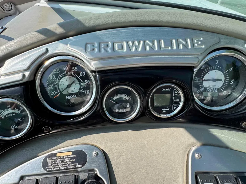 Slide: The Image of Dashboard of a 2010 Crownline 240 LS boat with speedometer and RPM gauges. - 12