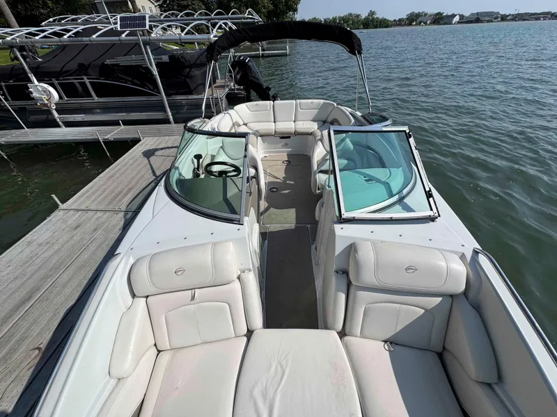Slide: The Image of 2010 Crownline 240 LS boat docked on a serene lake. - 7