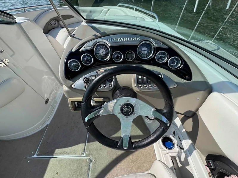 Slide: The Image of Steering wheel and dashboard of a 2010 Crownline 240 LS boat. - 9