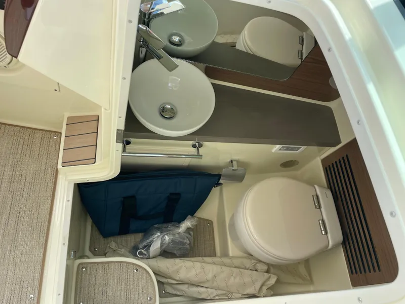 Slide: The Image of 2024 Chris-Craft Launch 31 GT boat bathroom with sink, toilet, and storage. - 11