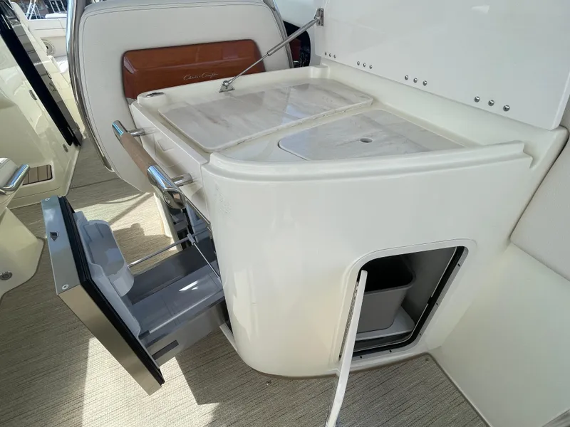 Slide: The Image of 2024 Chris-Craft Launch 31 GT boat interior with kitchenette and storage compartments. - 6
