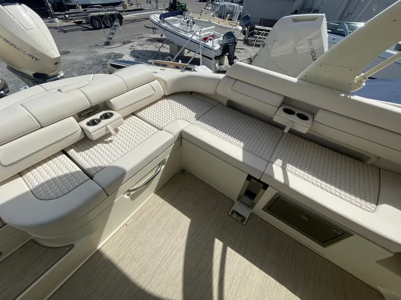 Slide: The Image of 2024 Chris-Craft Launch 31 GT boat interior with beige seating and cup holders. - 8