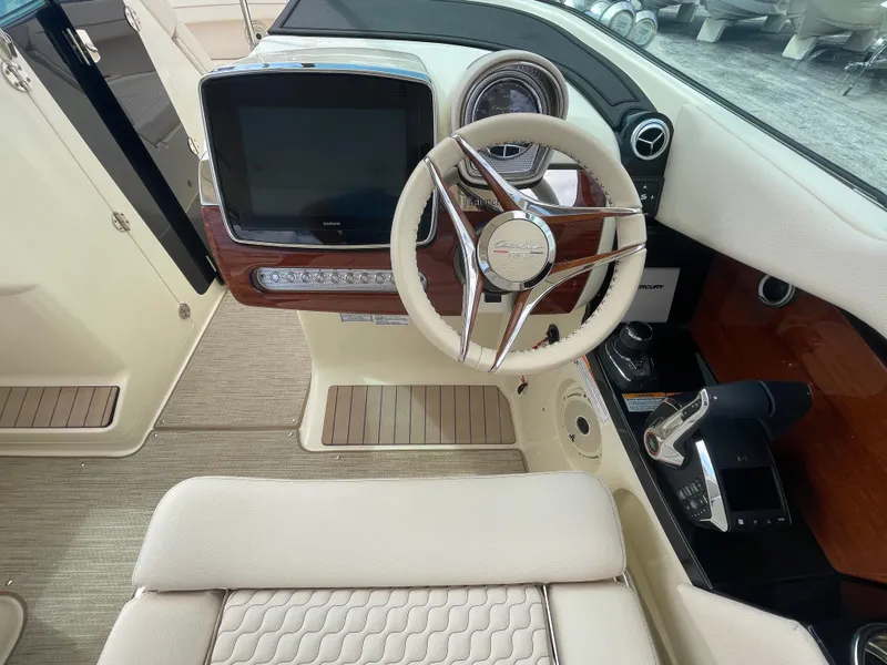 Slide: The Image of 2024 Chris-Craft Launch 31 GT helm with modern controls and luxurious interior. - 9
