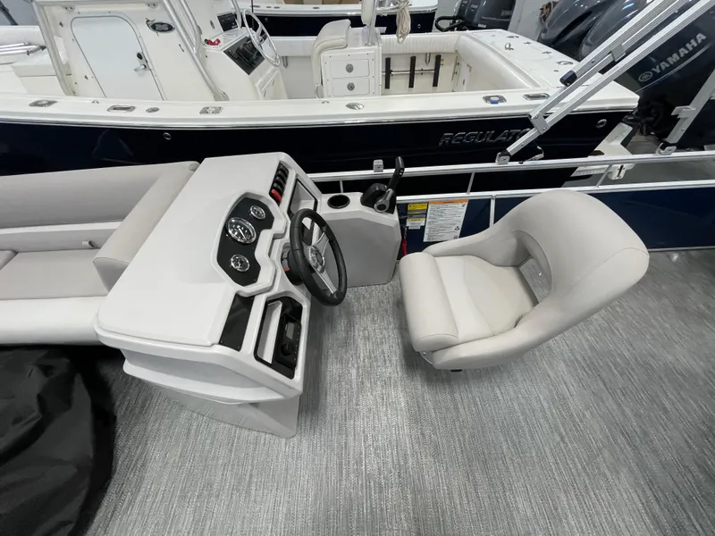 Slide: The Image of 2024 Godfrey Xperience 1880 FX boat interior with steering console and captain's chair. - 15