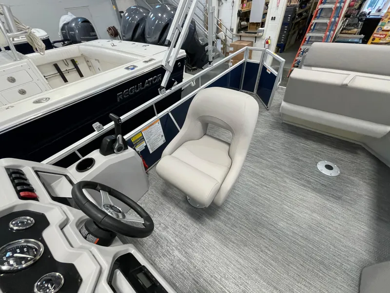 Slide: The Image of 2024 Godfrey Xperience 1880 FX boat interior with steering wheel and seating. - 16