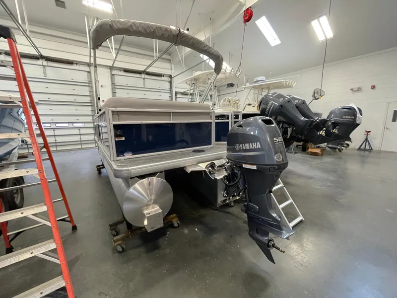 Slide: The Image of 2024 Godfrey Xperience 1880 FX pontoon boat in a garage with Yamaha outboard motor. - 20