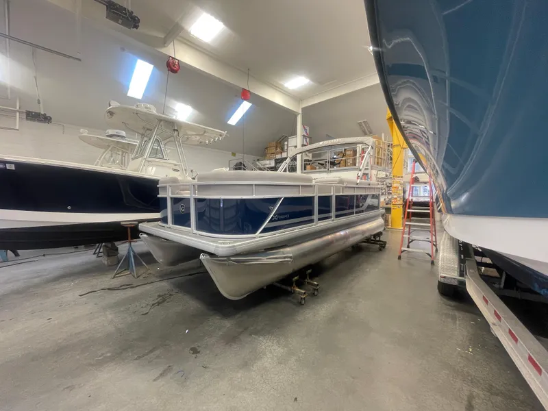 Slide: The Image of 2024 Godfrey Xperience 1880 FX pontoon boat in a showroom. - 3