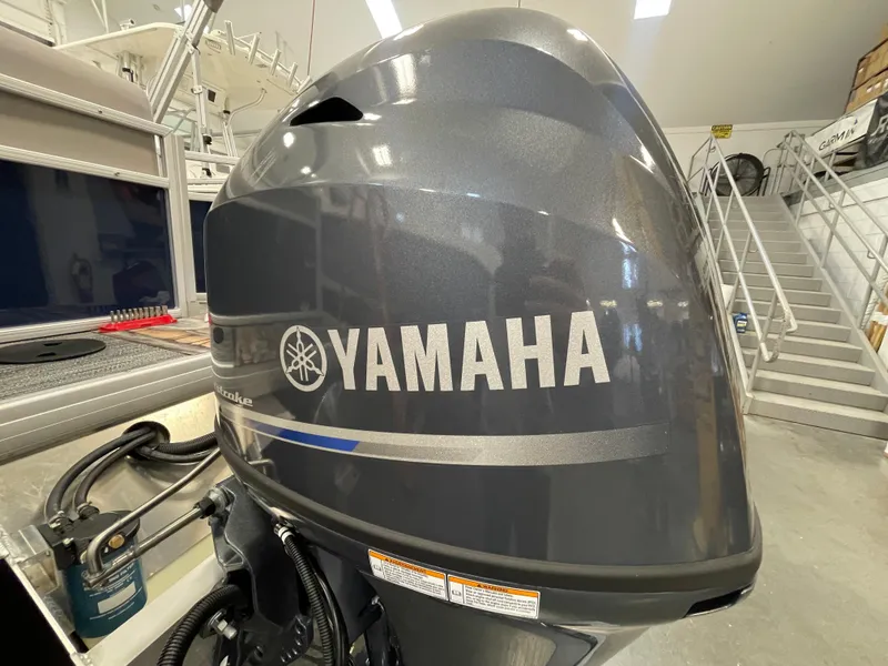 Slide: The Image of 2024 Godfrey Xperience 1880 FX with Yamaha outboard motor in showroom. - 8