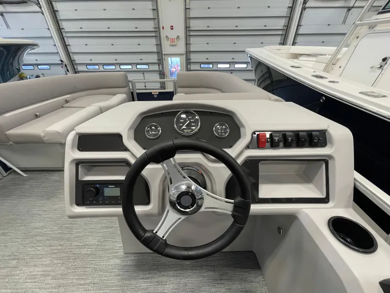 Slide: The Image of 2024 Godfrey Xperience 1880 FX boat dashboard with steering wheel and control panel. - 9