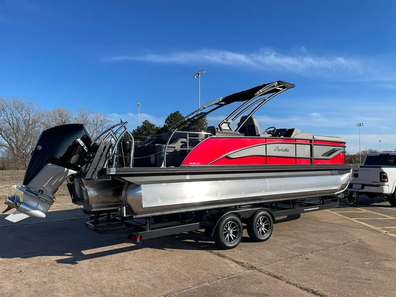 Slide: The Image of 2024 Barletta CORSA 23UCA pontoon boat with red and silver exterior on a trailer. - 12